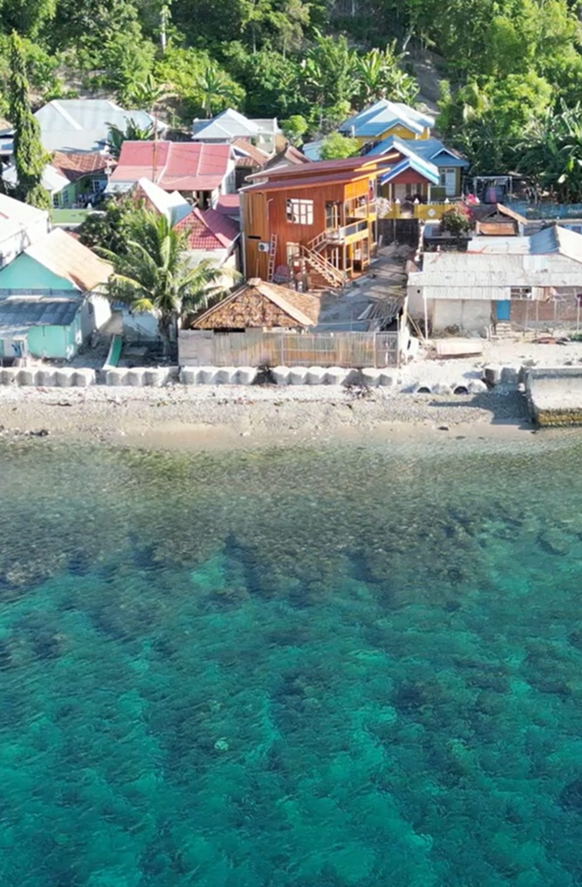 Aerial view of GoRo dive resort on the Botubarani shoreline with the house reef in front
